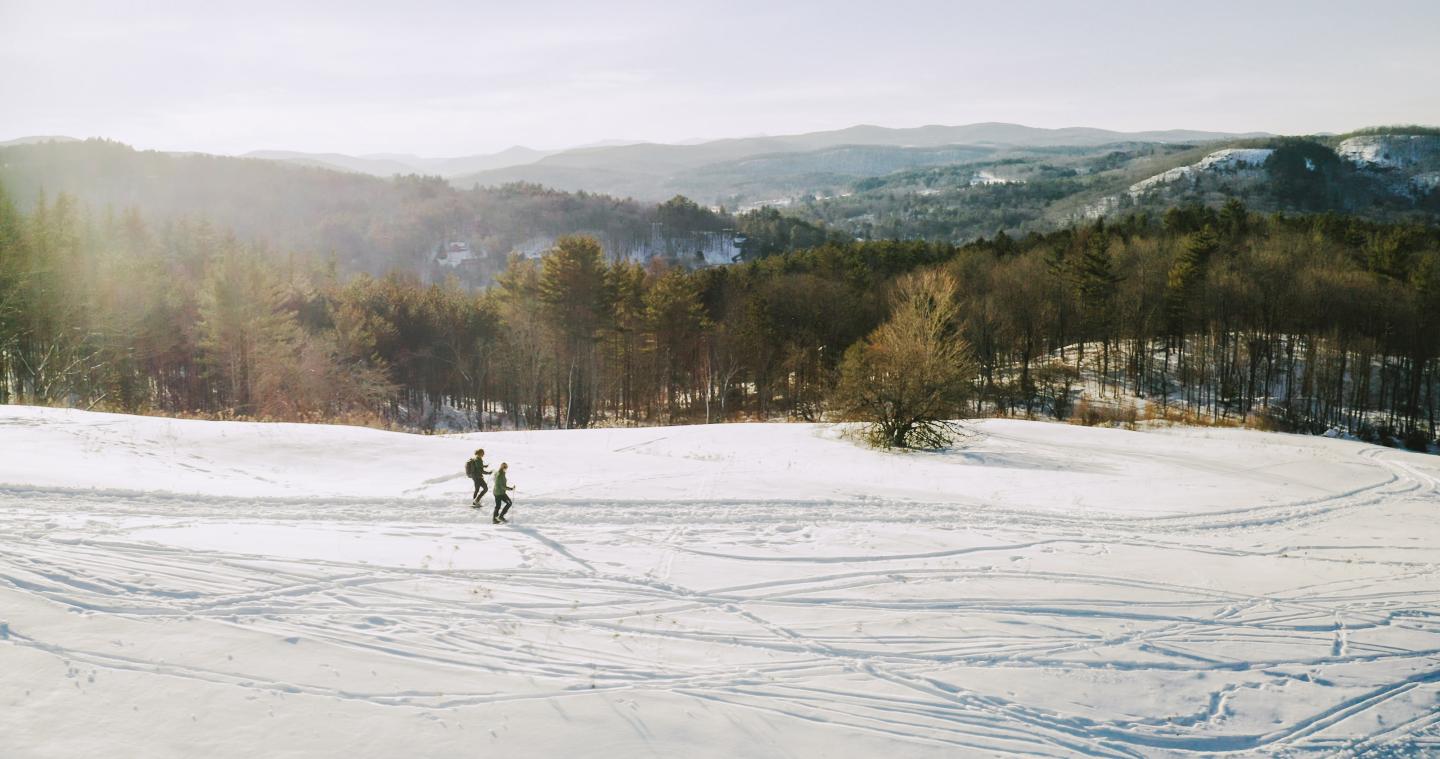 2 Snowshoers on Mt Peg with mountain views