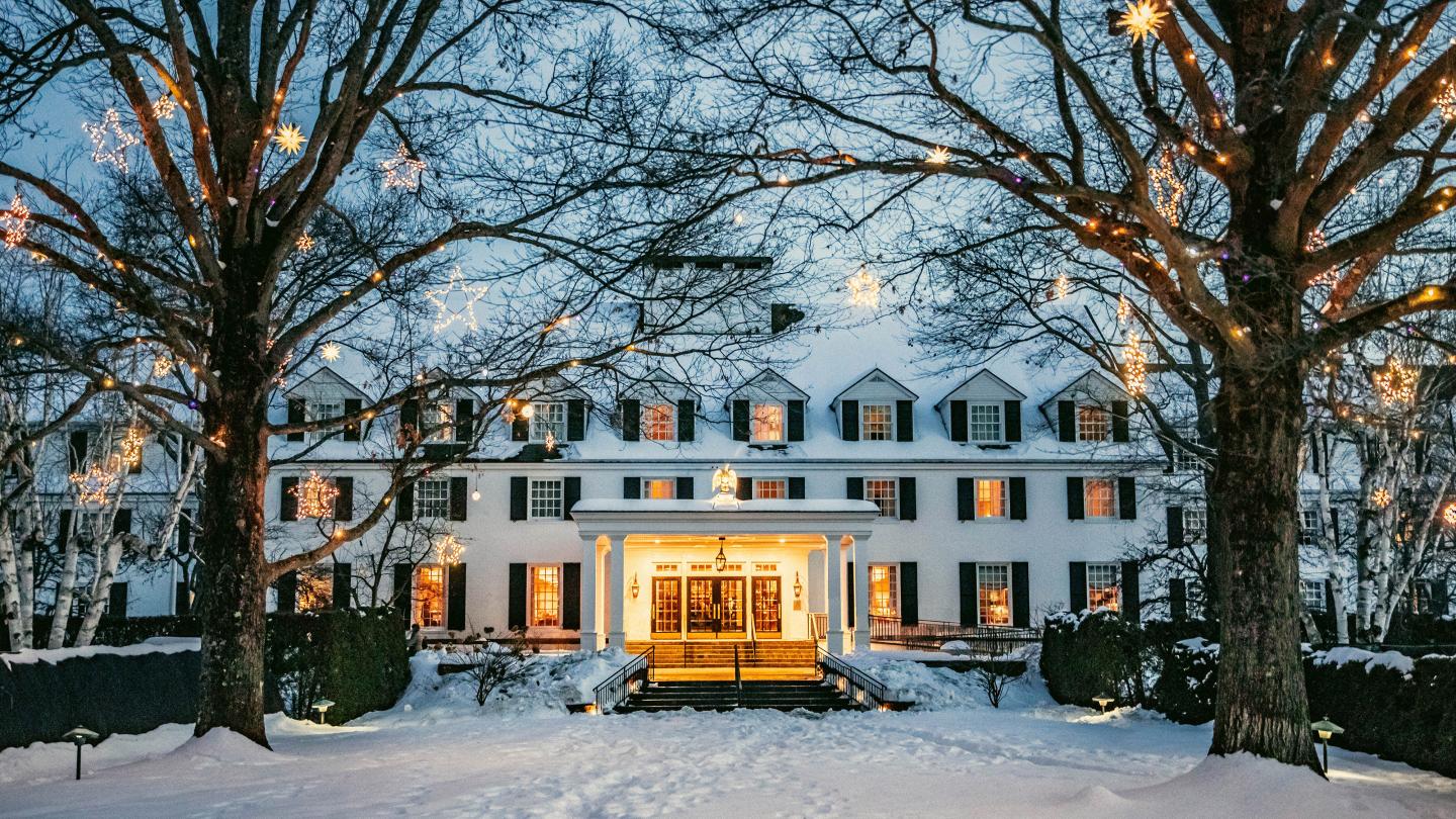Woodstock inn with fresh snow and twinkling lights in the trees