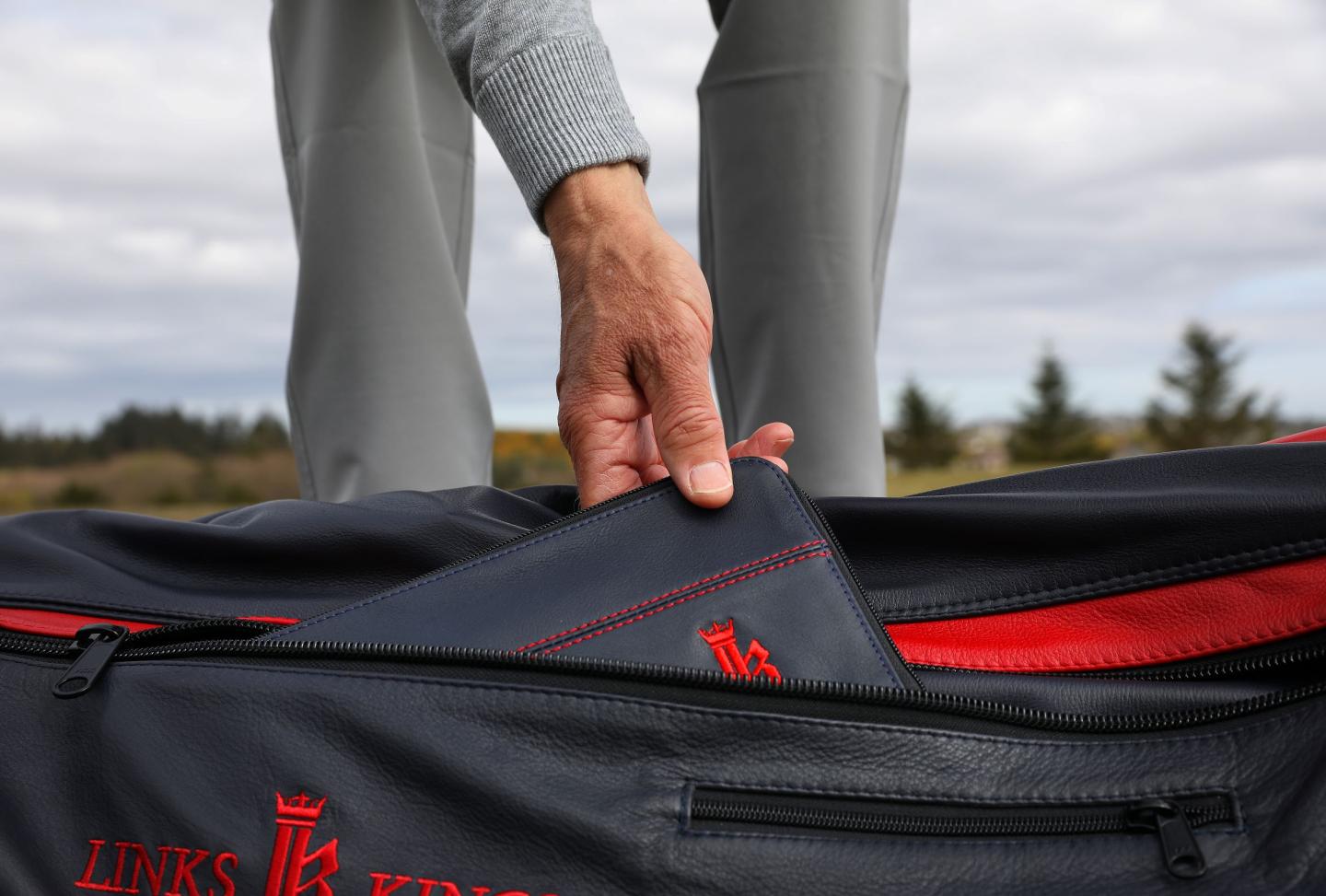 Golfer reaching into his bag for a golf glove pouch