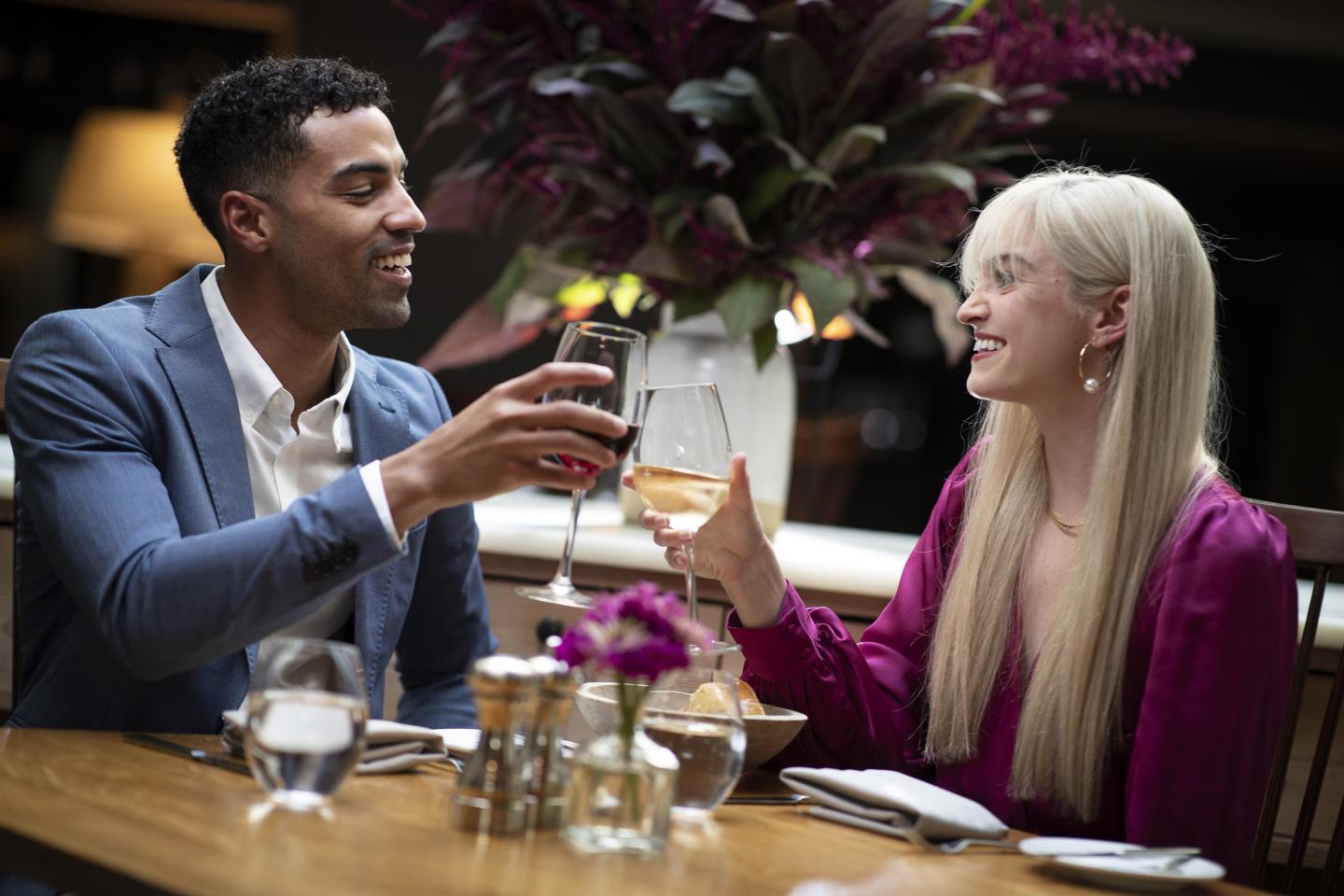 Couple Dining and clinking wine glasses