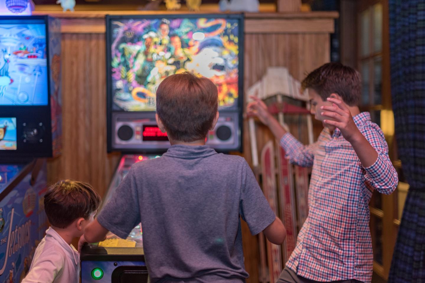 3 brothers playing retro pinball game