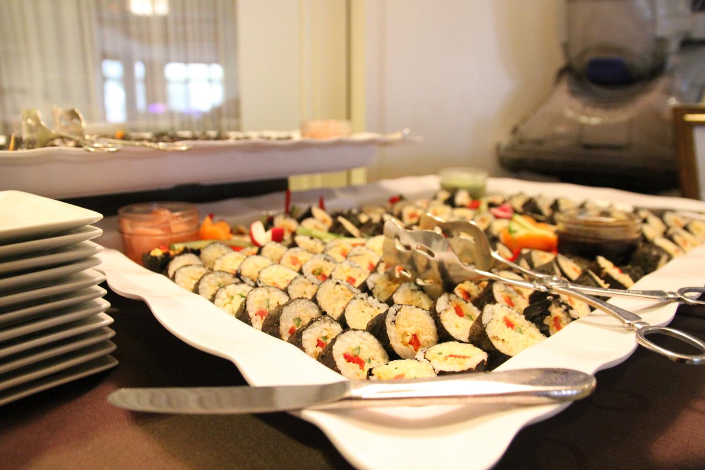 Plate of Sushi with serving tongs