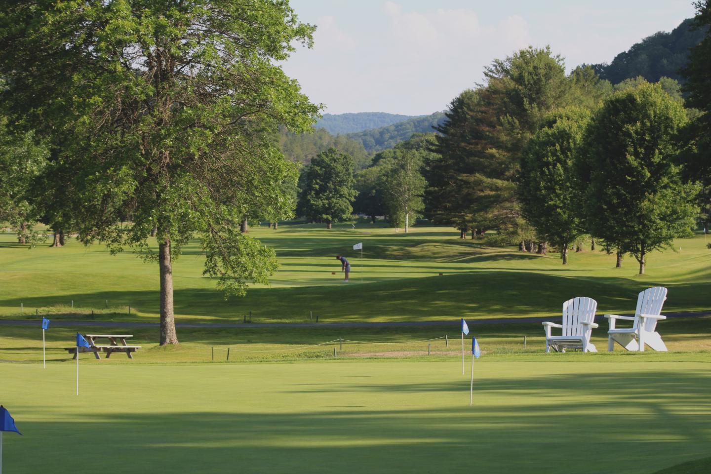 looking over the practice area at a golfer putting at the Woodstock Country Club