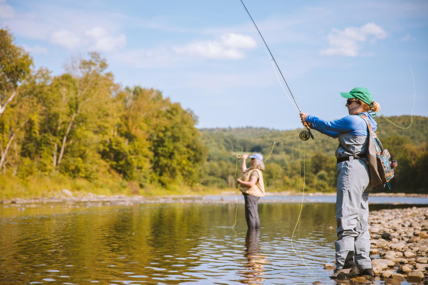 Two women fly casting on the White River