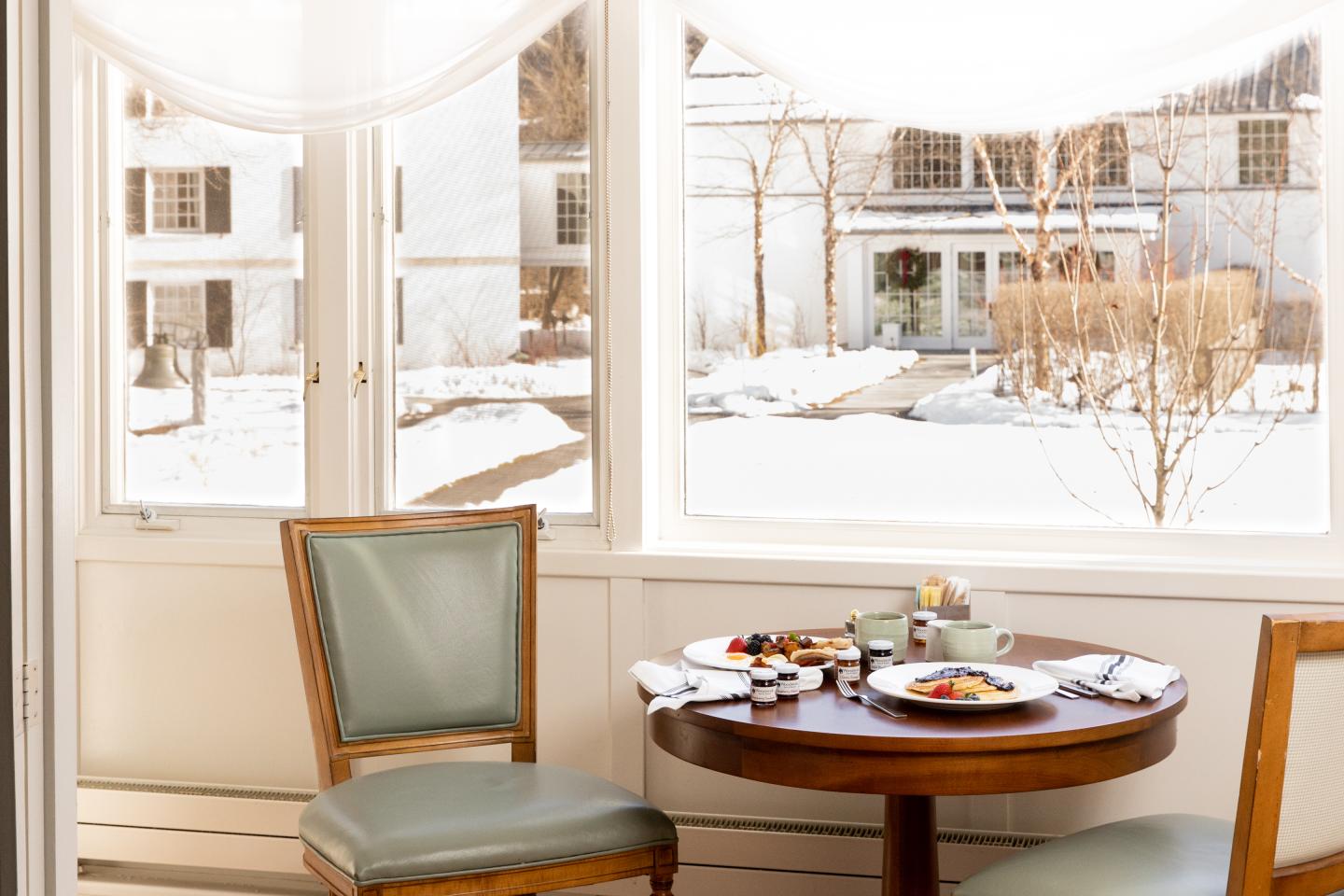 Room service dishes displayed on a table with a snowy background