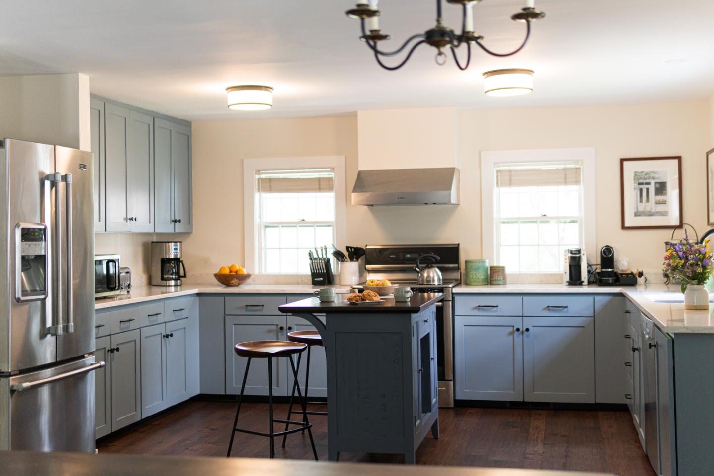 Large kitchen with light blue cabinets.