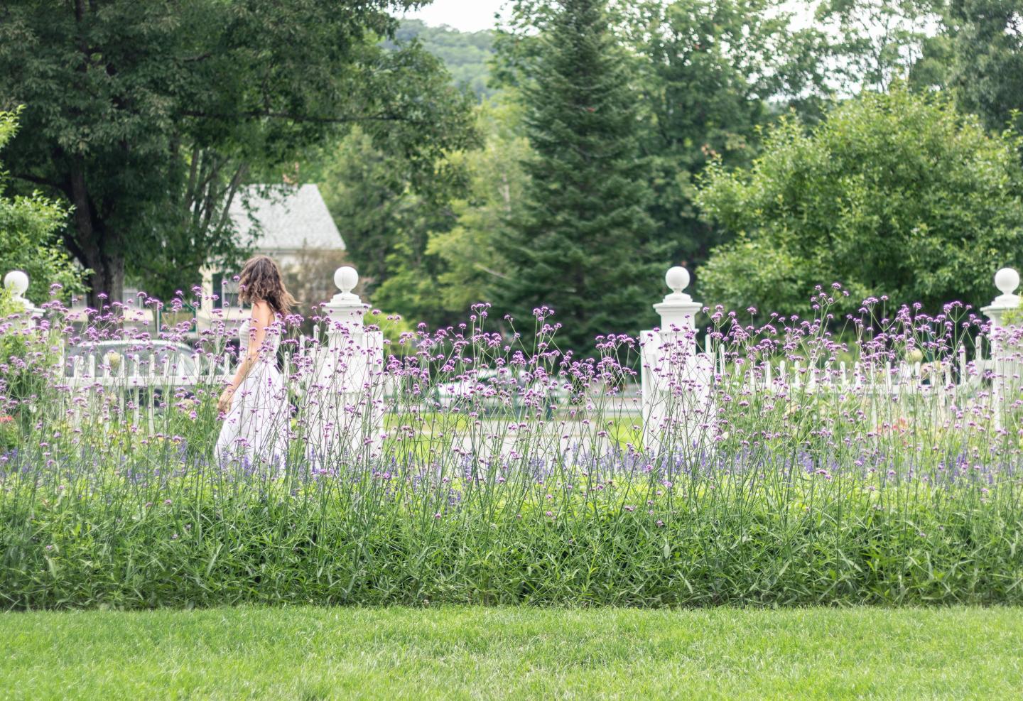 Woman walking through flowers