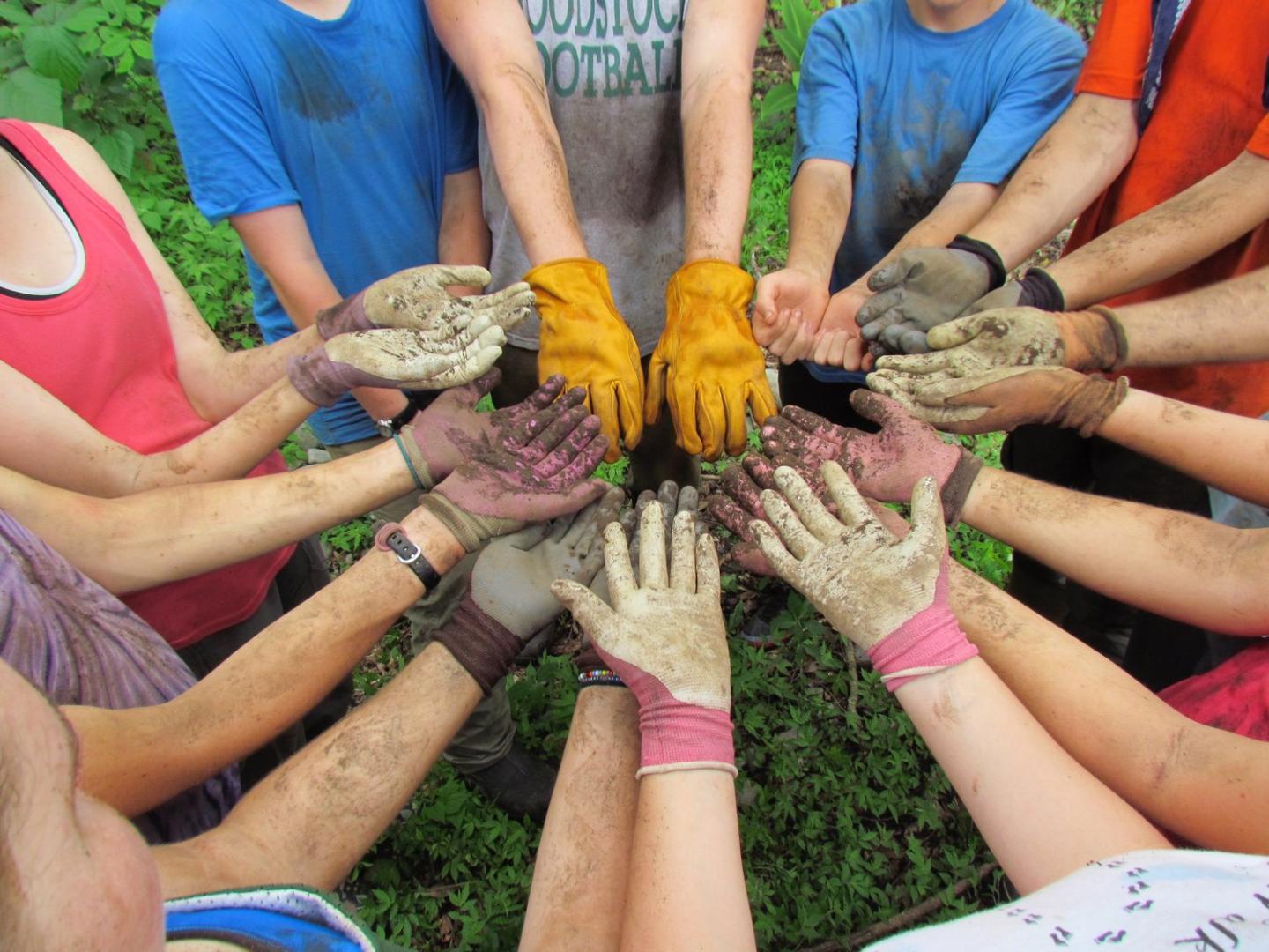 group of teens at Change The World Kids with hands in a circle