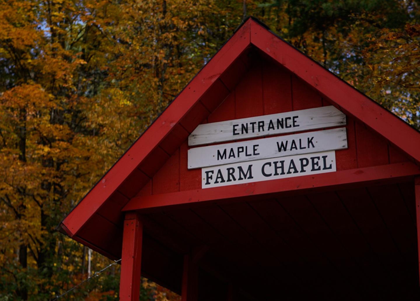 Red entrance bridge to Maple Walk & Farm Chapel
