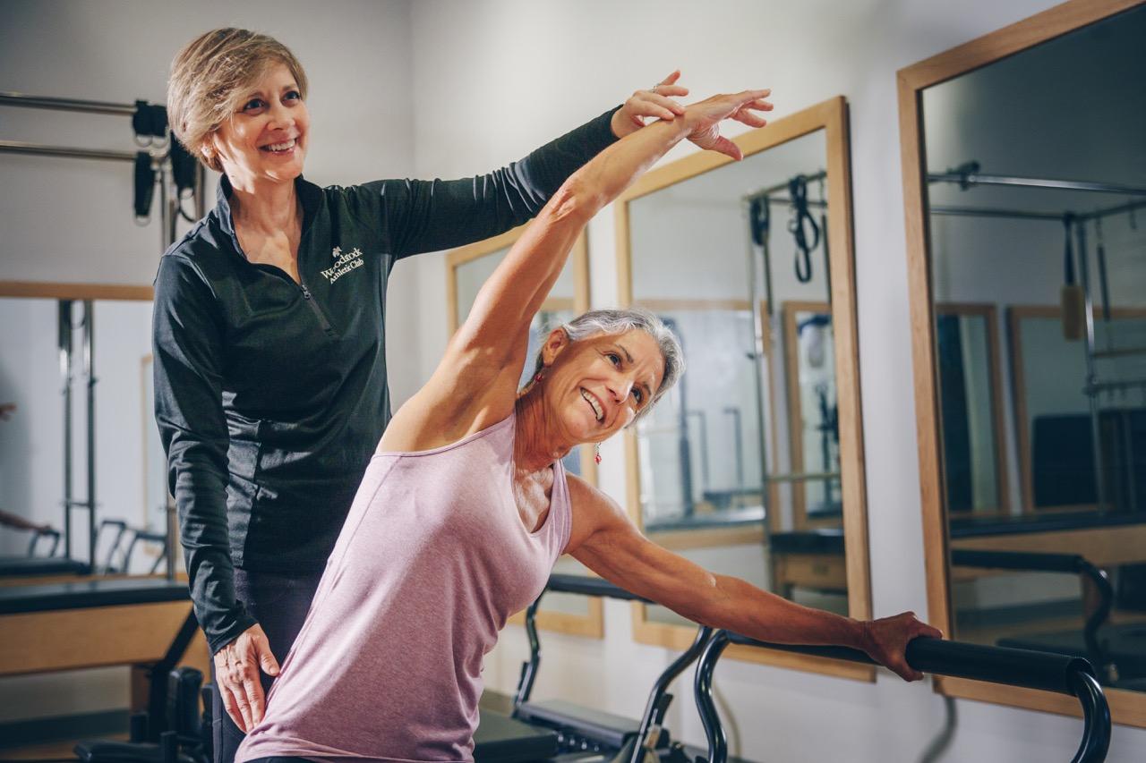 Trainer helping a client during a workout session