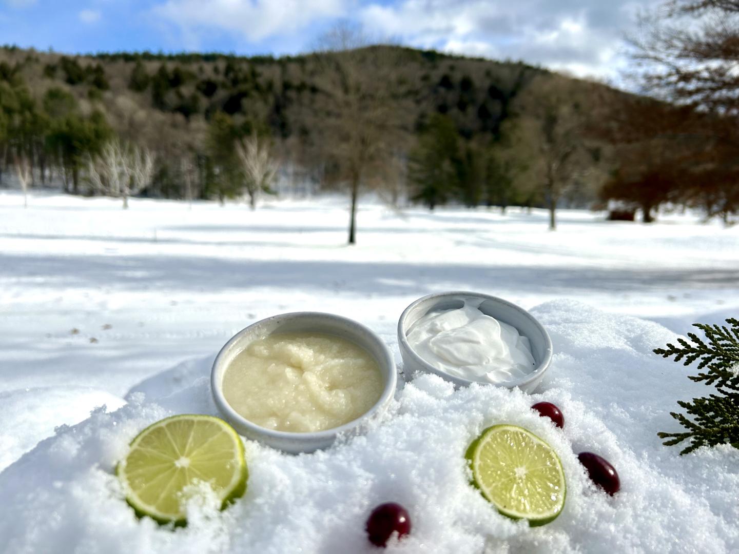Spa products in the snow with a mountain in the background