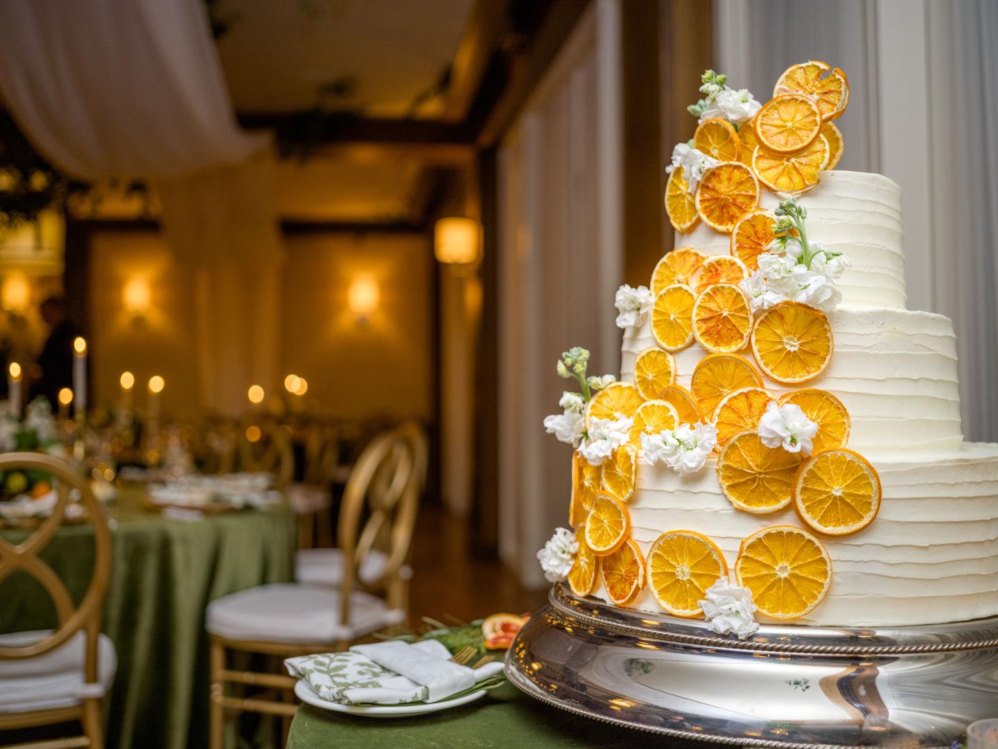 White cake with orange slices adorning it