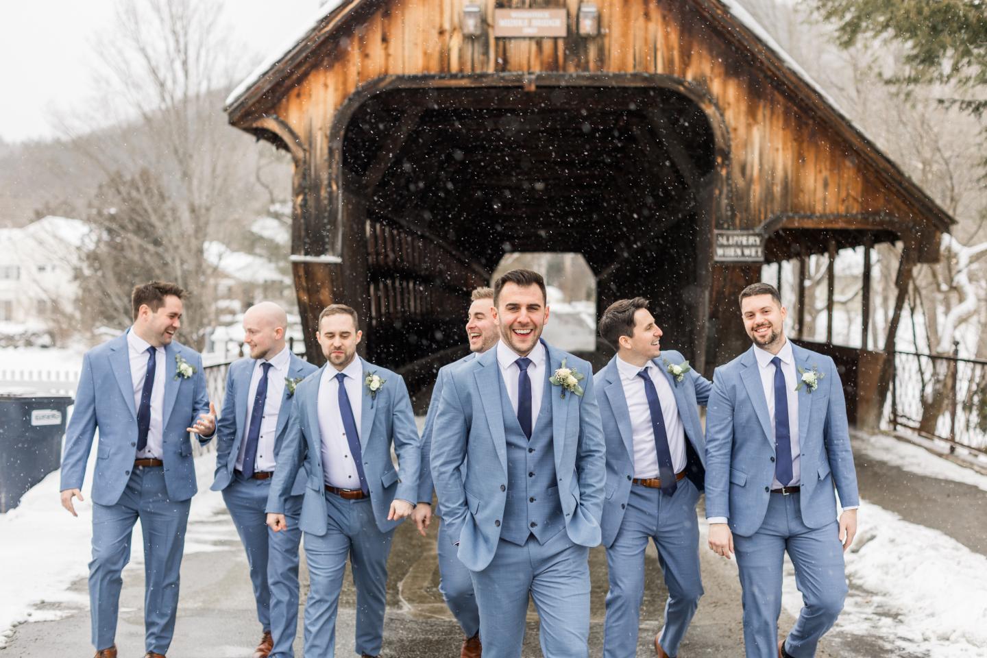 Groomsmen under covered bridge