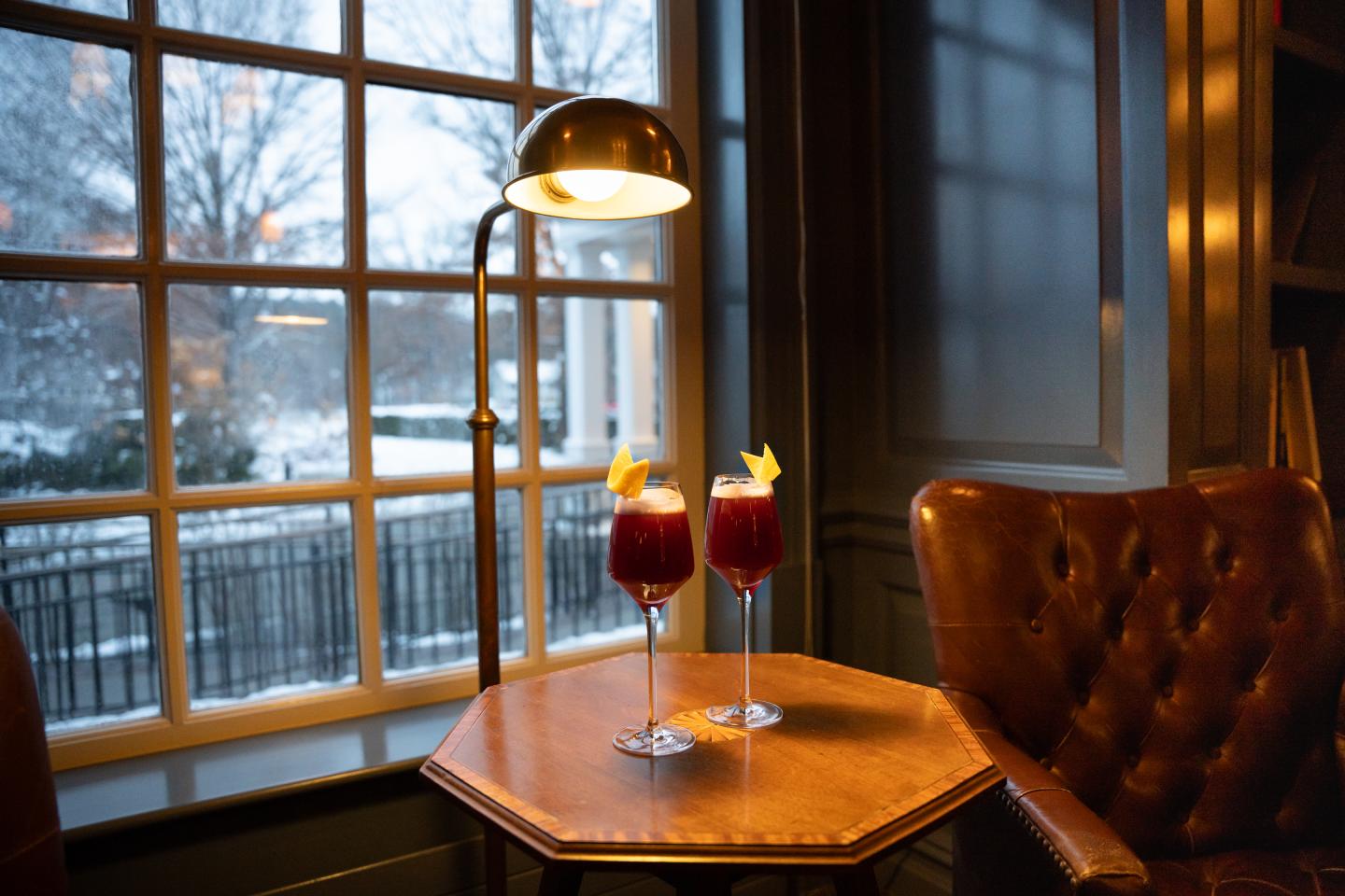 Two specialty cocktails sit in the Woodstock Inn Library