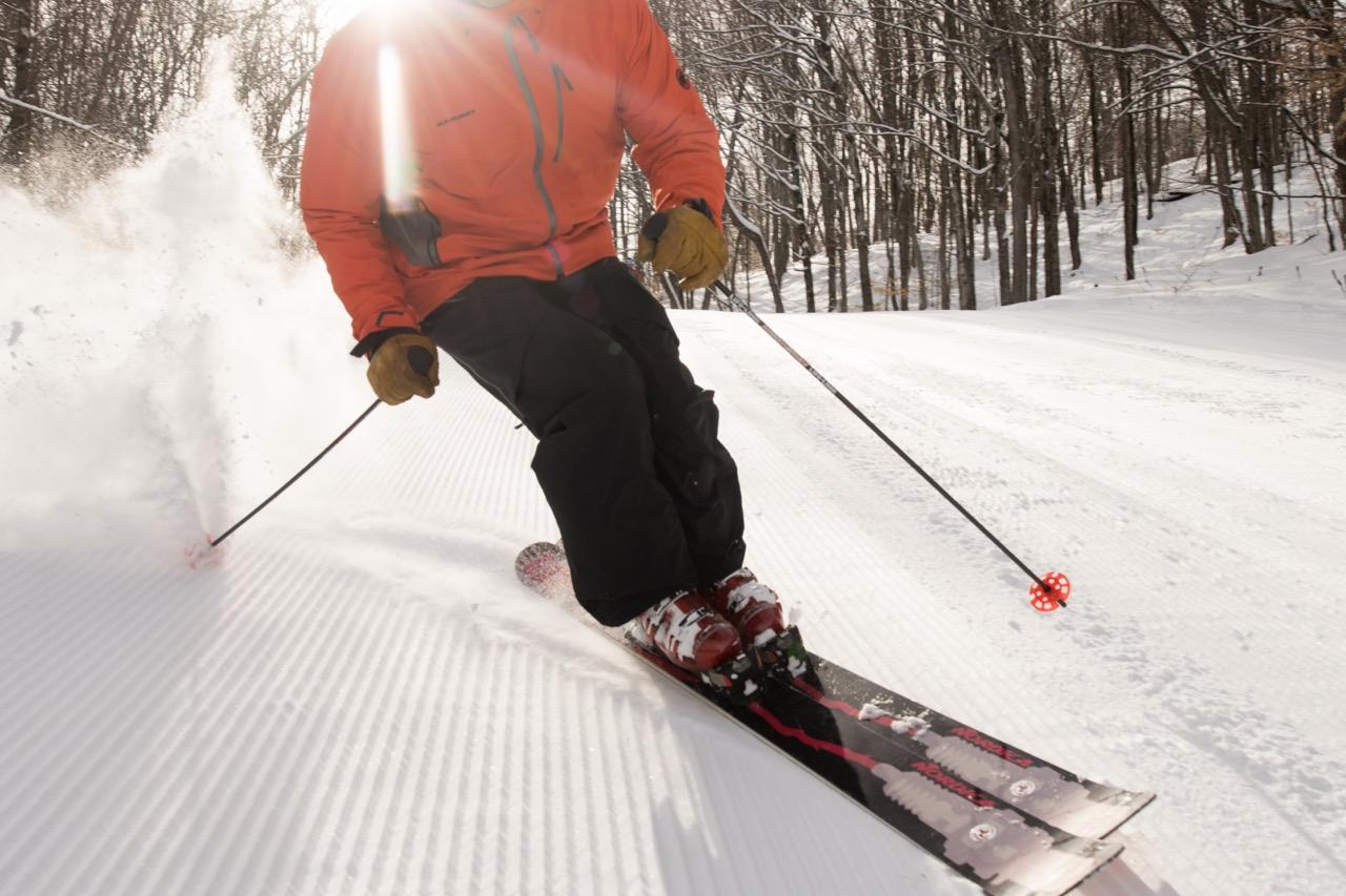Alpine skier on a groomed slope