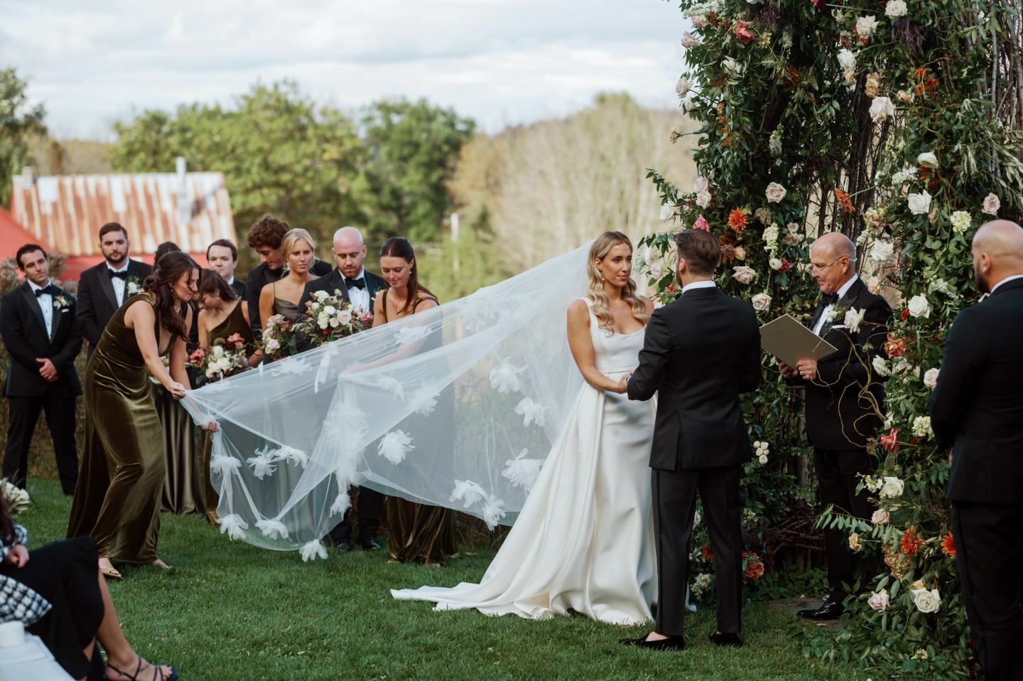 Bride and groom holding hands at the altar