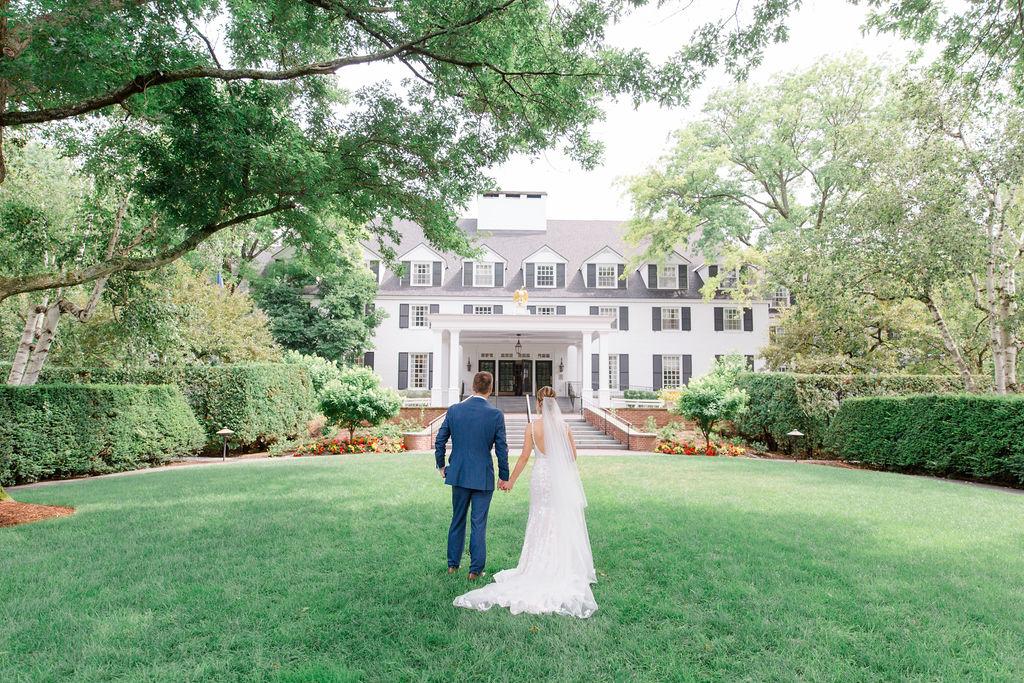 bride & groom in front of the inn on a summer day