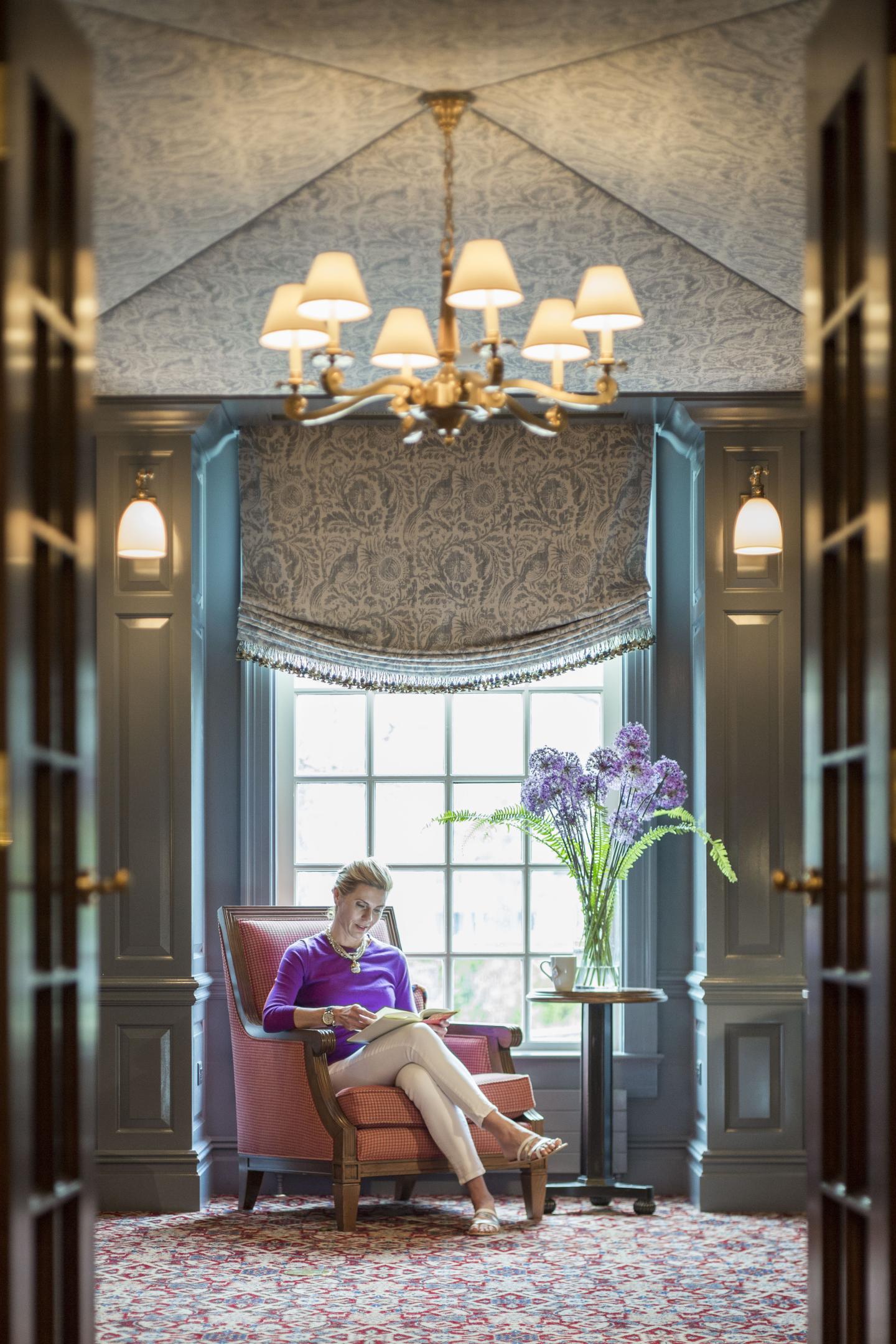 Woman reading in the Library at the Woodstock Inn & Resort