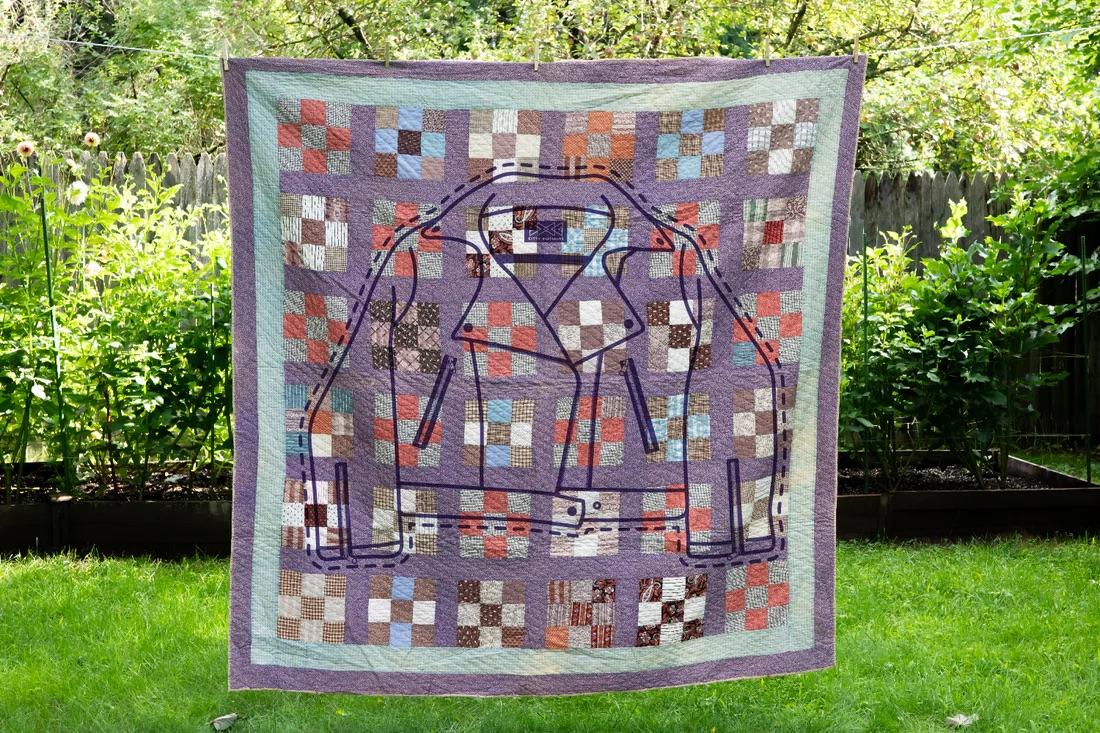 Quilt with outline of a jacket to show repurpose potential 