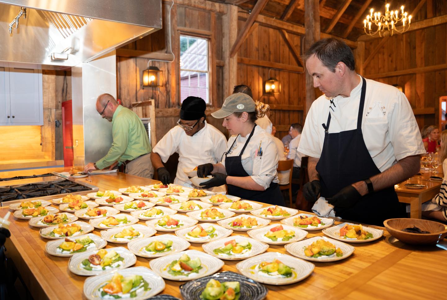 three chefs plating salads