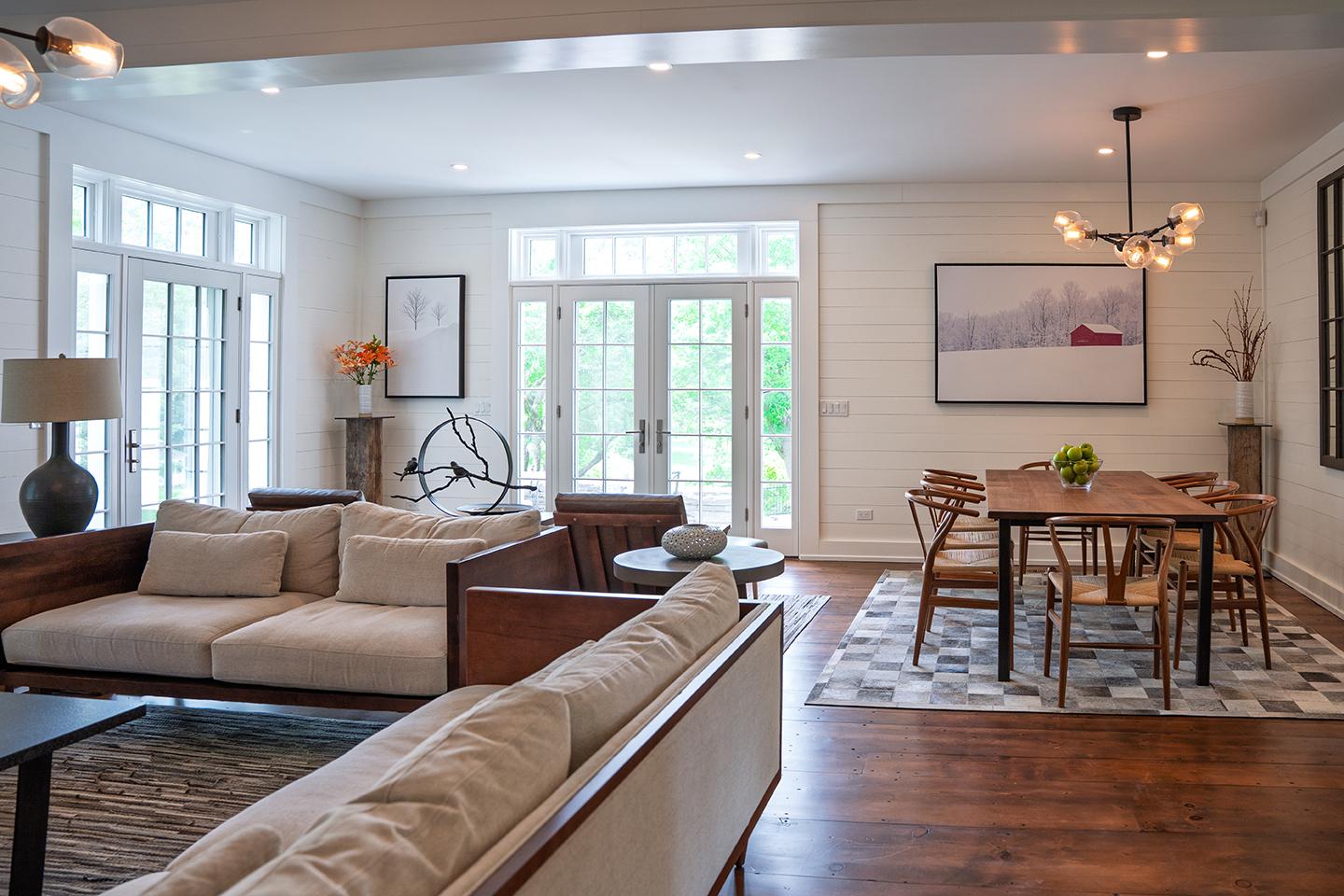 Spacious living room and dining area with modern furniture and natural light.
