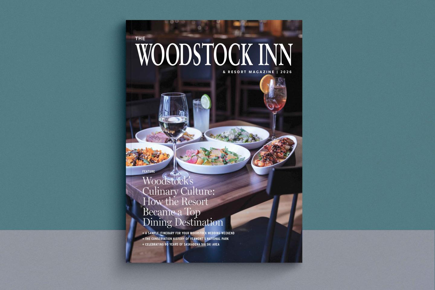 Restaurant menu cover featuring drinks and dishes on a wooden table.