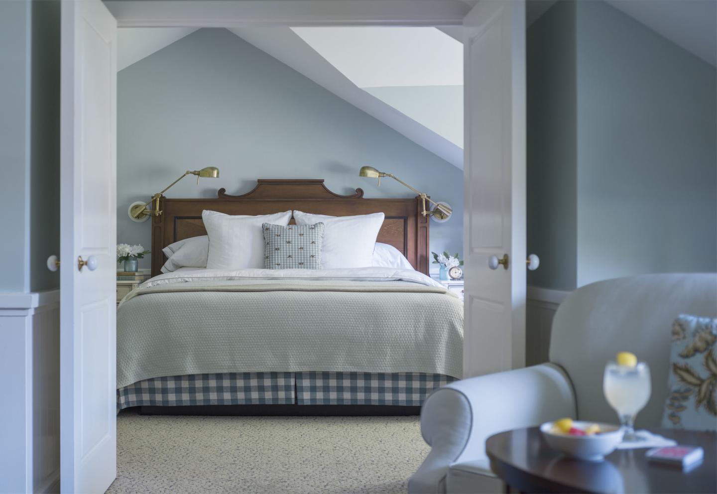 Cozy bedroom with a large bed, white bedding, and soft lighting.