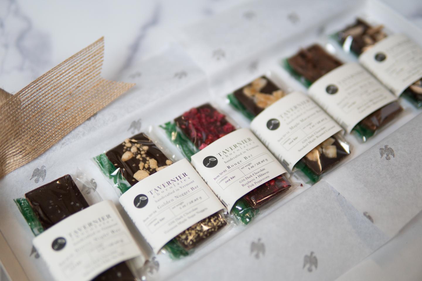 Rows of small wrapped tea packets displayed on a table.