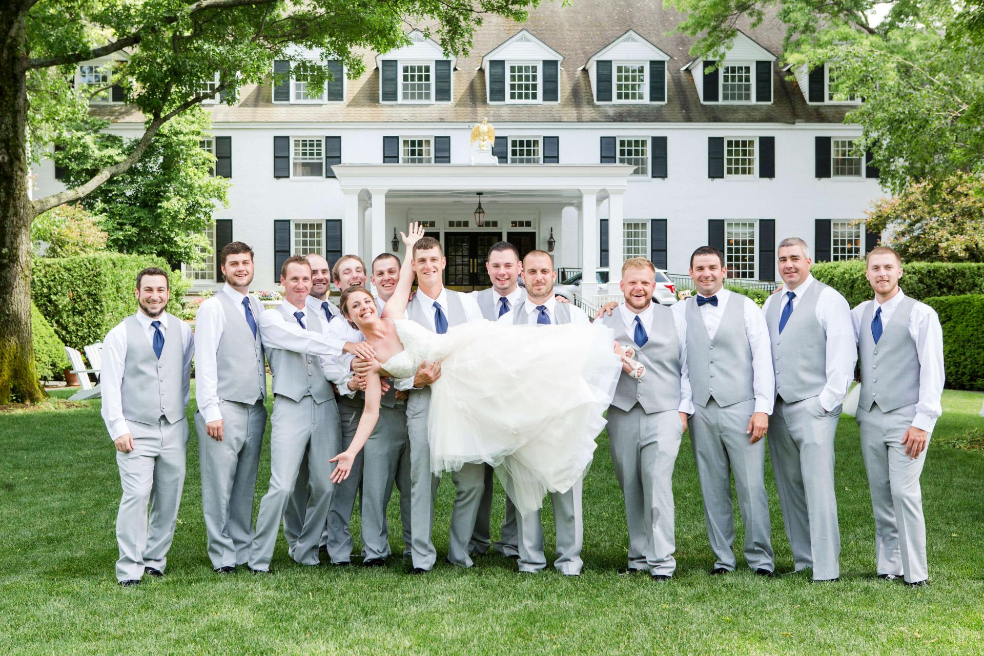 Groomsmen holding bride
